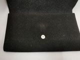 an open black purse with a button on the inside of it