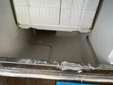 a dirty sink in the corner of a bathroom