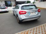 a silver car that is parked on the side of the road