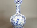 a blue and white vase sitting on top of a table