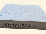 the base of a cement block with the word bennies written on it