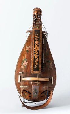 an old musical instrument that is sitting on a stand