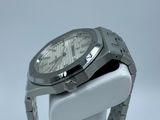 a close up of a watch on a white stand on a white surface