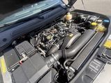 un moteur de voiture dont le capot est ouvert dans la rue