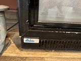 a close up of a microwave on a wooden table