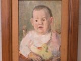 tableau représentant un bébé avec un bol de fruits, dans un cadre en bois