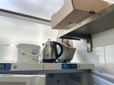 a tea kettle sitting on top of a stove in a kitchen