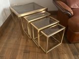 three tables that are sitting on a wooden floor