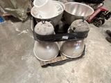 a pile of bowls and pans on the floor in a room