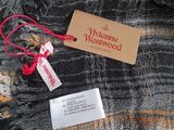 a tag on a plaid shirt that is hanging on a hanger