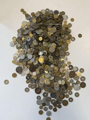 a pile of coins sitting on a white surface