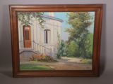 un tableau représentant une maison avec une porte rouge dans un cadre en bois