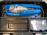 a tool box with a cordless drill and other tools in it
