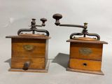 pair of antique wooden coffee grinders with brass handles