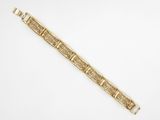 un bracelet en or orné de motifs de fleurs et de feuilles