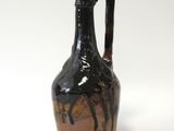 un vase noir et marron orné d'un cheval