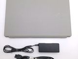 a laptop with a charger and a power cord on the table