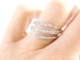 a woman ' s hand with a diamond ring on it