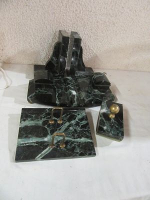 a black and green marble clock on a white table