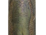 a gold vase with a picture of a man on it