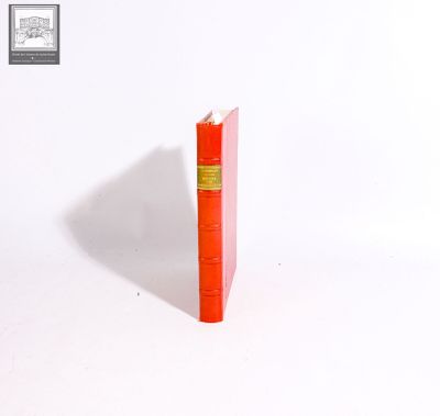 a red book that is sitting on a white surface
