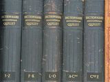 many old books in a box on a shelf