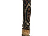 a tall wooden pole with a decorative design on it