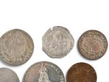 several different types of coins are shown on a white surface