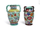 two vases sitting next to each other on a white surface