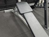 a bench with a weight plate on it in a gym