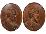 une paire de portraits en bois sculpté représentant un homme et une femme