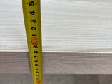 a close up of a measuring tape on top of a wooden table