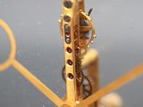 a close up of a gold clock with gears on it