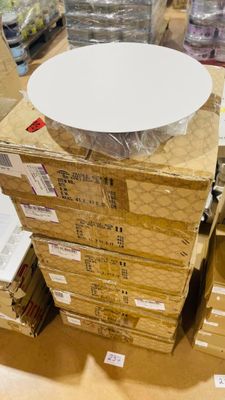 a stack of boxes with a white plate on top of it