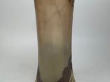 a vase that is sitting on a white surface