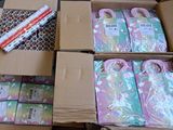 many boxes of wrapping paper sitting on a table