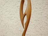 wooden sculpture of a fish on a wooden base on a table
