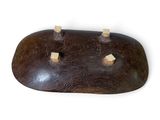 a wooden object that is sitting on a white surface