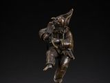 a bronze figure of a man with a bird on his shoulder
