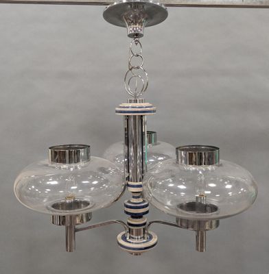 a chandelier with three glass globes hanging from the ceiling