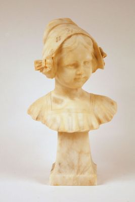 marble bust of a young girl with a hat on her head