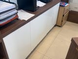 a desk with a computer and printer on top of it