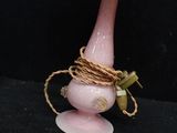 a pink lamp that has a rope wrapped around it