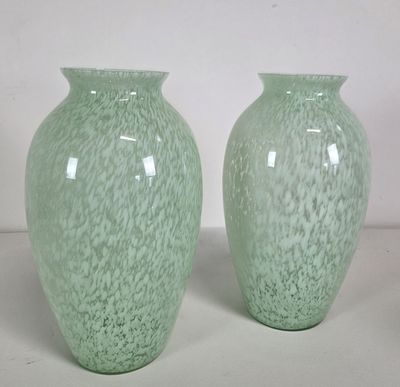 two green vases sitting next to each other on a table