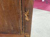 a brown wooden cabinet with a hole in it