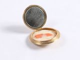 a gold locke with a fish in it on a white surface