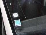 a man sitting in the back seat of a car with a cell phone in his hand