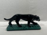 figurine of a black panther on a green base