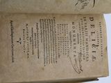 an old book that is open on a table