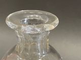 a clear glass vase with rocks inside of it
